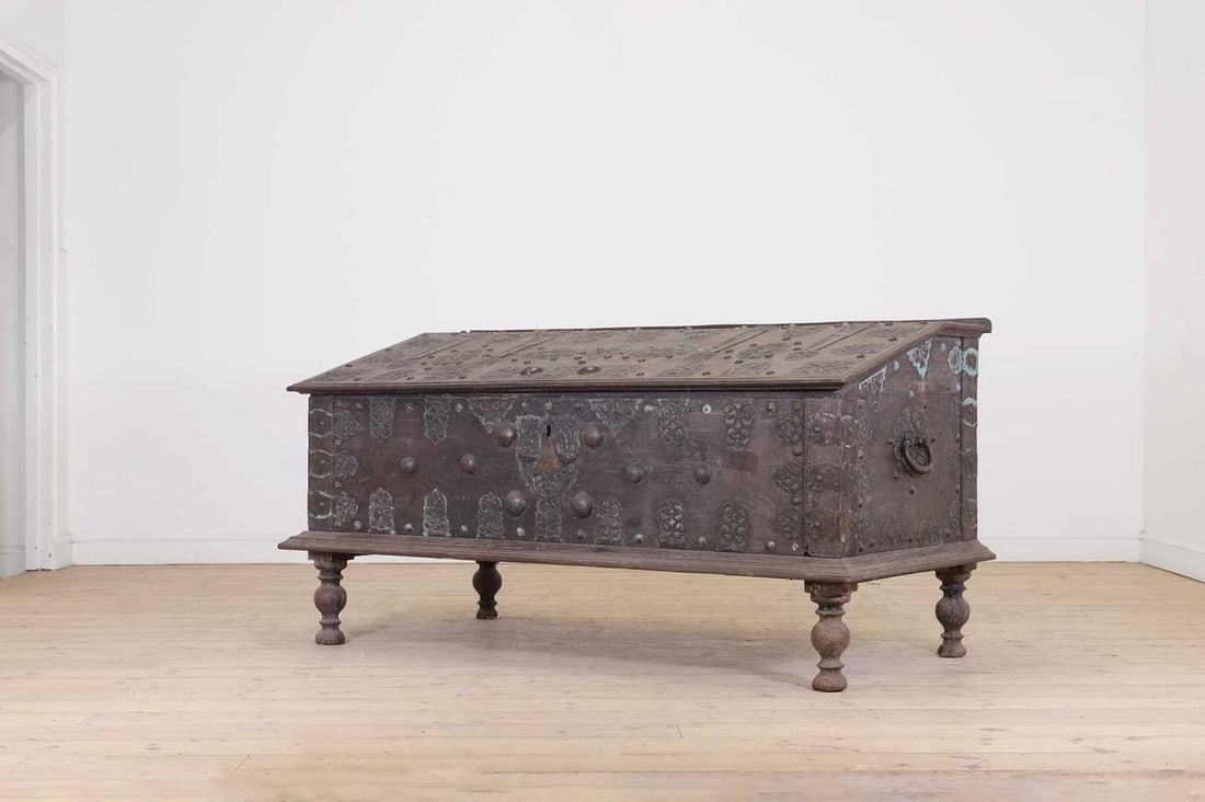 A large hardwood and brass chest,: A large hardwood and brass chest, A large hardwood and brass chest, 19th century and later, Ceylonese, the sloping hinged lid enclosing an interior with divisions, raised on turned supports, 168cm wid