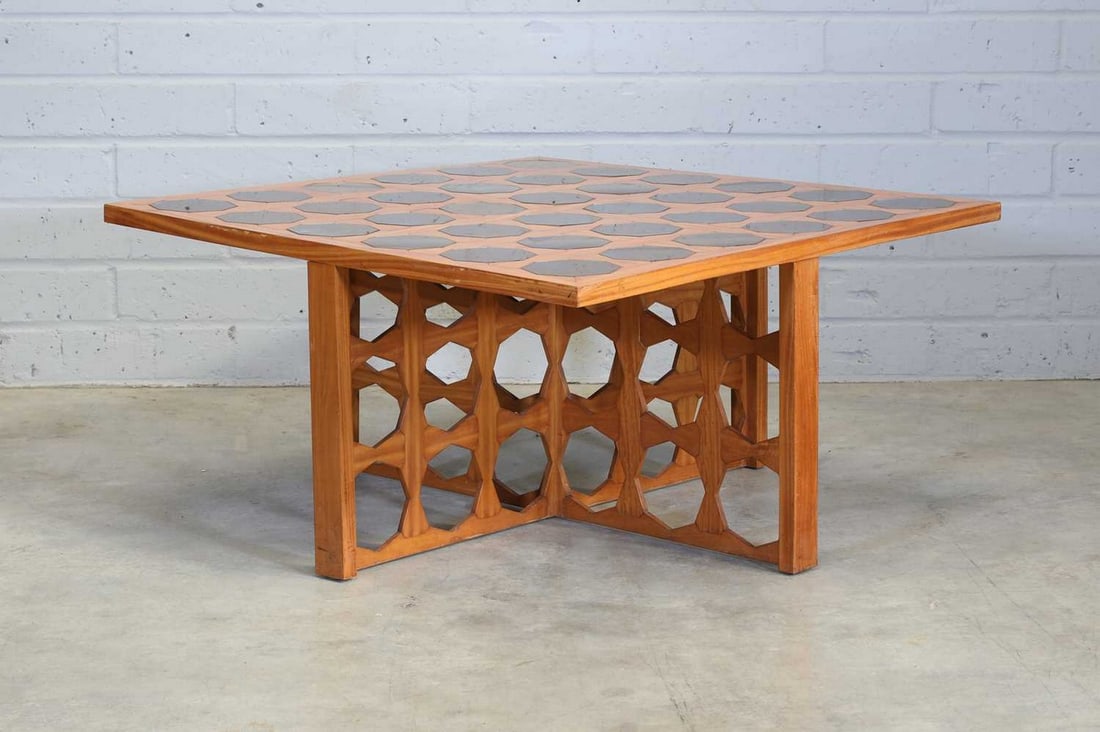 John Makepeace (b.1939),: John Makepeace (b.1939), c.1972, a satinwood coffee table, with thirty-six octagonal acid-treated glass panels to the top, raised on a cruciform stand, with octagonal cut panels, 100cm wide 100cm deep