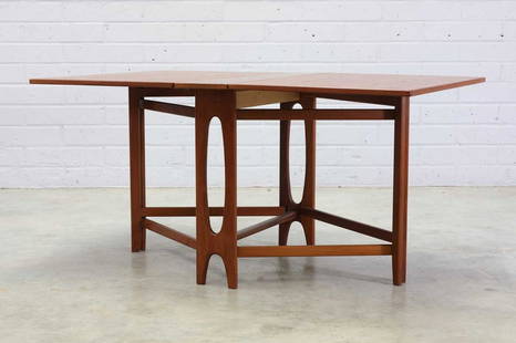 A Norwegian 'Ellipse Nr. 2' teak drop-leaf table,: A Norwegian 'Ellipse Nr. 2' teak drop-leaf table, 1950s, designed by Bendt Winge for Kleppes Møbelfabrikk, the leaves raised on either side by crossed supports, the central section raised on scul