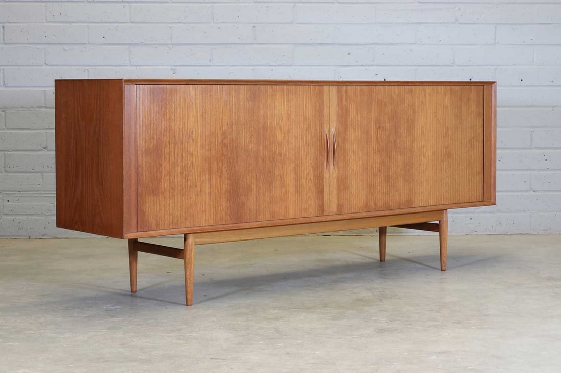 A Danish teak tambour-fronted sideboard,: A Danish teak tambour-fronted sideboard, 1960s, designed by Arne Vodder for Sibast, the pair of tambour doors opening on to a compartmentalised interior all with adjustable shelving, the second compar