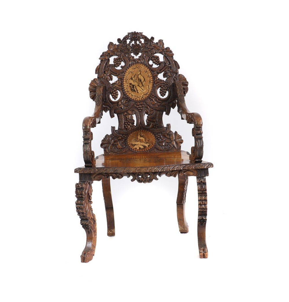 A carved Black Forest elbow chair, (1 of 5)
