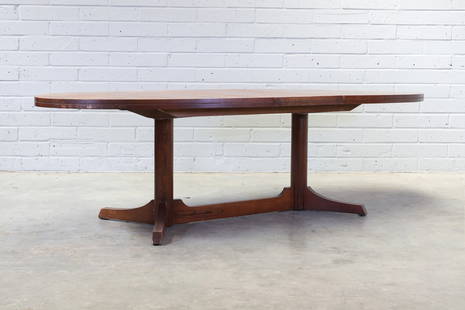 § An extending rosewood dining table,: § An extending rosewood dining table, 1950s, designed by Robert Heritage for Archie Shine, the oval top raised on pillar supports, terminating on to tripod supports joining at the middle, 202cm w