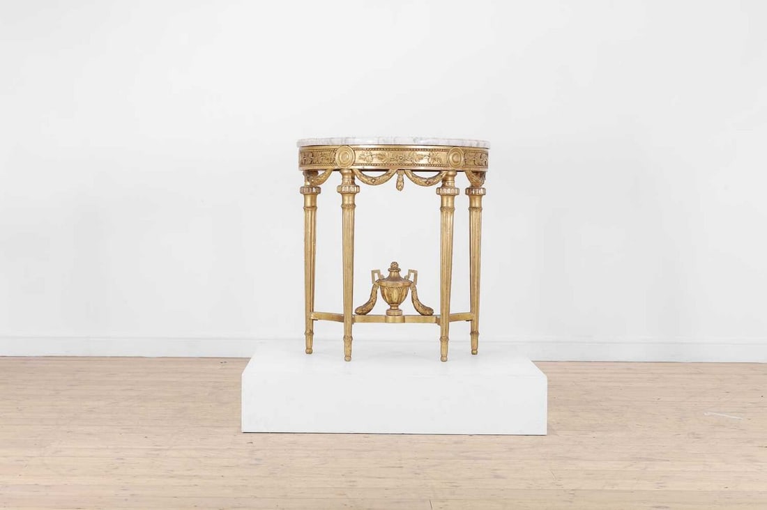 A Gustavian-style giltwood pier table,: A Gustavian-style giltwood pier table, late 19th century, Swedish, of demilune outline with a grey marble top, raised on fluted supports, 77cm wide 42cm deep 86cm high