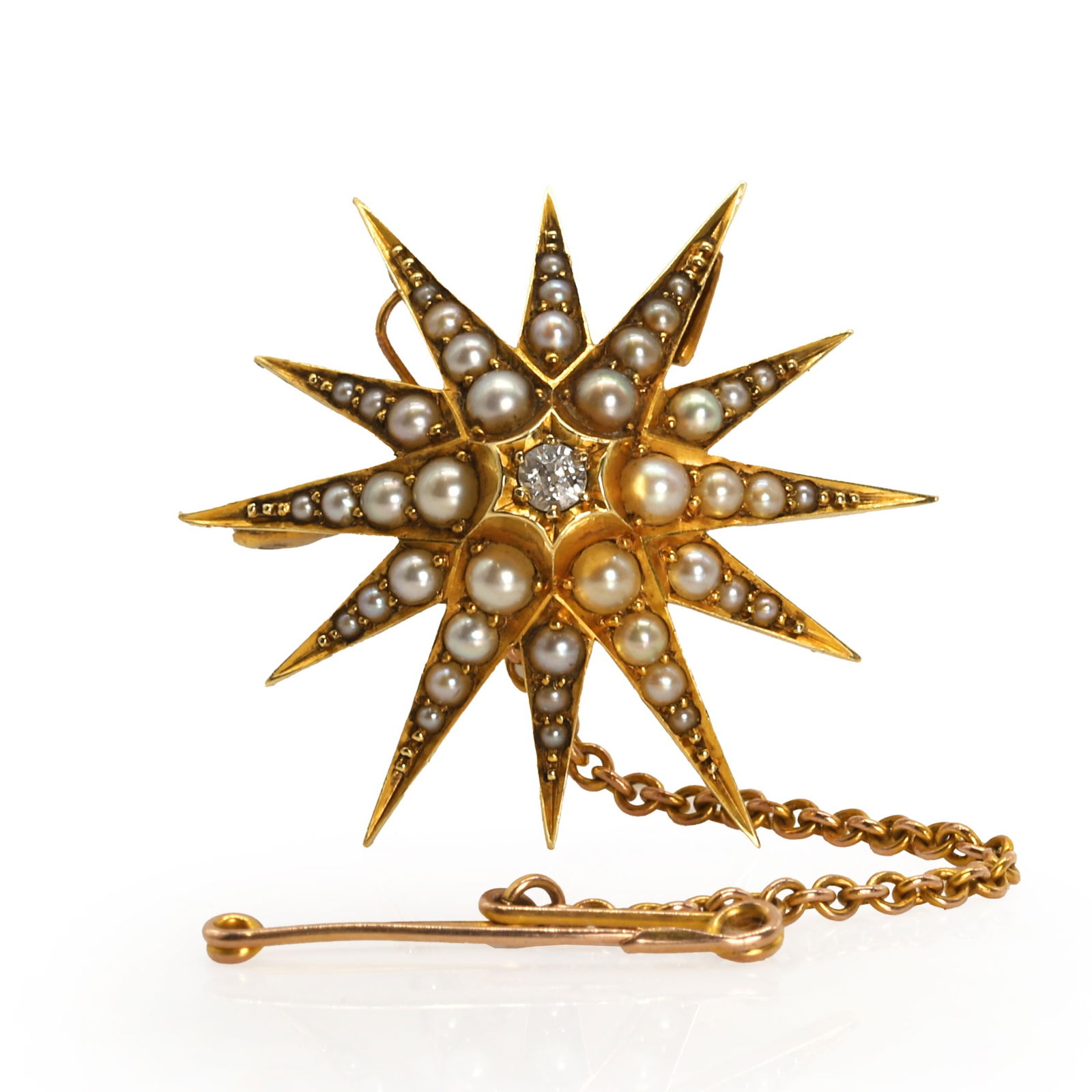 An Edwardian gold split pearl and diamond starburst brooch, (1 of 2)