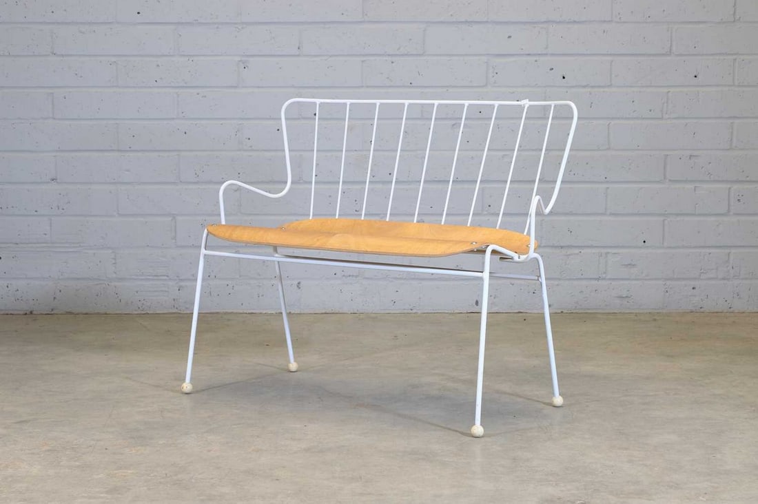 An 'Antelope' bench,: An 'Antelope' bench, modern, originally designed in 1950 by Ernest Race for 'The Festival of Britain', manufactured by Race Furniture Ltd., the painted steel frame with a spindle back over a plywood s