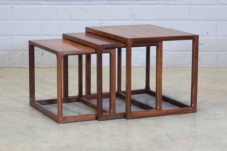 &#167; A Danish rosewood nest of three tables,: &#167; A Danish rosewood nest of three tables, 1970s, designed by Aksel Kjersgaard for Feldballes M&#248;belfabrik, each with chamfered supports, 59.5cm wide 43.5cm deep 44.5cm high (3) Condition Repo