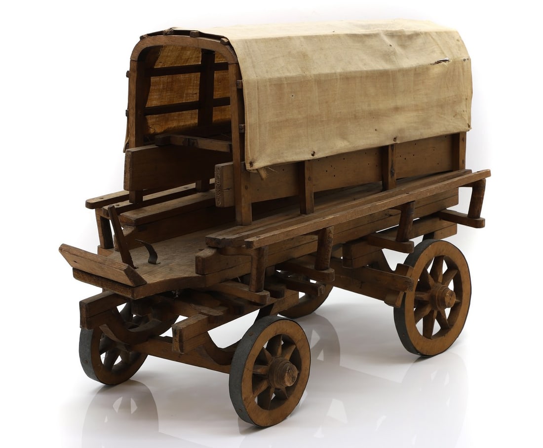 Of Boer War Interest,: Of Boer War Interest, a wood model of a Boer Wagon, with a cloth hood, with metal clad wheels, 40cm high 51cm long Provenance: Surgeon Vice-Admiral Sir James Porter (1851-1935), thence by descent. Por