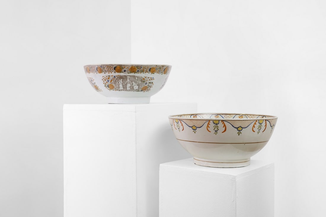 Two delftware tin-glazed earthenware punchbowls,: Two delftware tin-glazed earthenware punchbowls, early-mid 19th century, English, one decorated in predominantly blues and oranges, inscribed to the centre 'Mr Robert Smith/see Toun Carnbulge', 29cm w