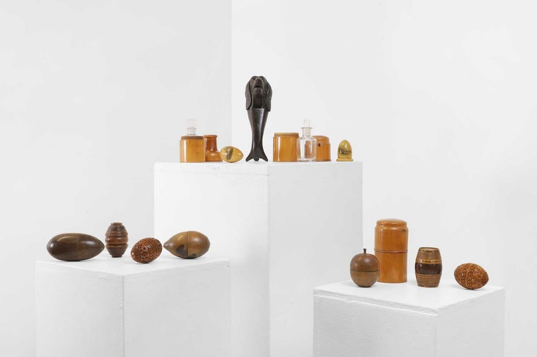 A collection of treen,: A collection of treen, 19th century and later, comprising three bottle cases, two with glass bottles and stoppers, a Lowestoft commemorative egg, two nutmeg graters, a nutcracker in the form of a dog'