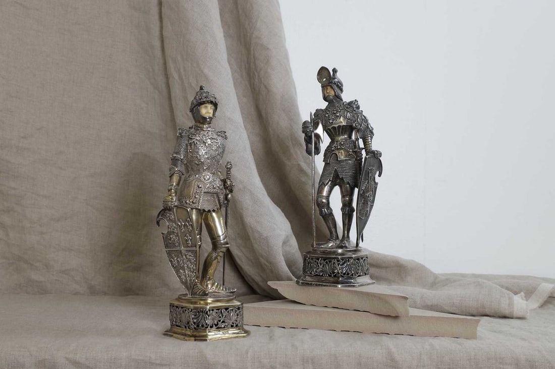 A pair of silver and ivory-mounted figures, (1 of 16)