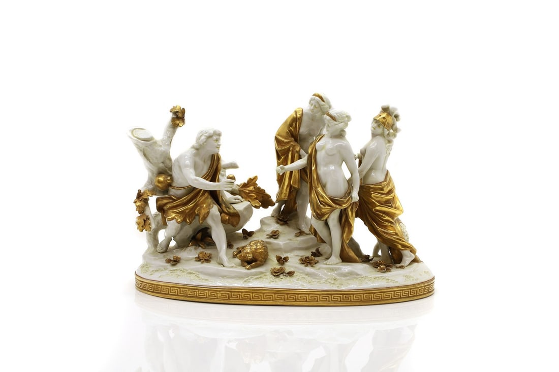 A Capodimonte porcelain figural group,: A Capodimonte porcelain figural group, 19th century, depicting the ‘Judgement of Paris’, heightened in gilt, painted mark, 32cm wide 21cm high Condition Report: The trees missing branches,