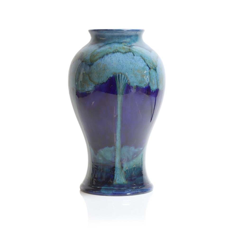 A William Moorcroft 'Moonlit Blue' vase,: A William Moorcroft 'Moonlit Blue' vase, c.1925, of baluster form, decorated with trees against a cobalt blue ground, signed 'W. Moorcroft' in underglaze green and impressed 'Made in England Moorcroft