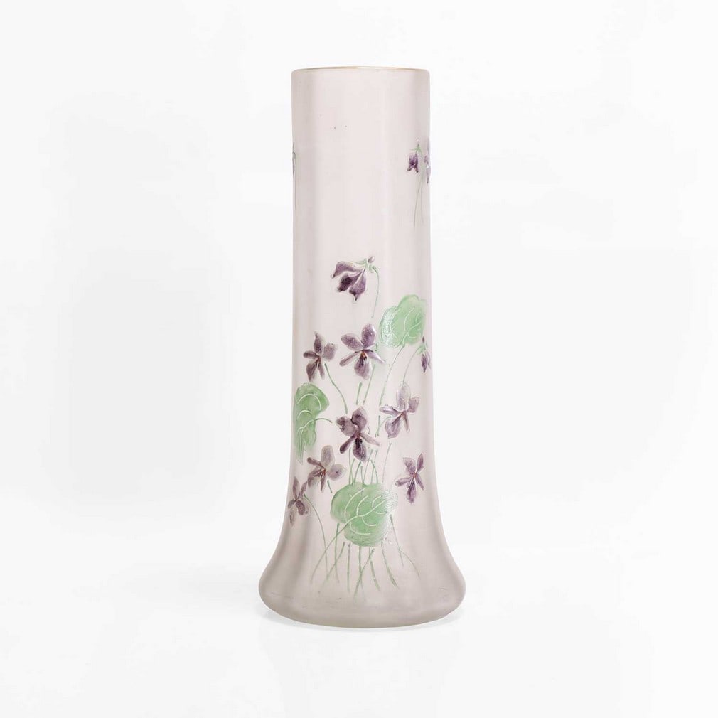 A Mont Joye enamelled glass vase,: A Mont Joye enamelled glass vase, c.1910, produced by the Auguste Légras glassworks, the squat bulbous body with a tall cylindrical faceted neck, with enamelled decoration of violets against a froste