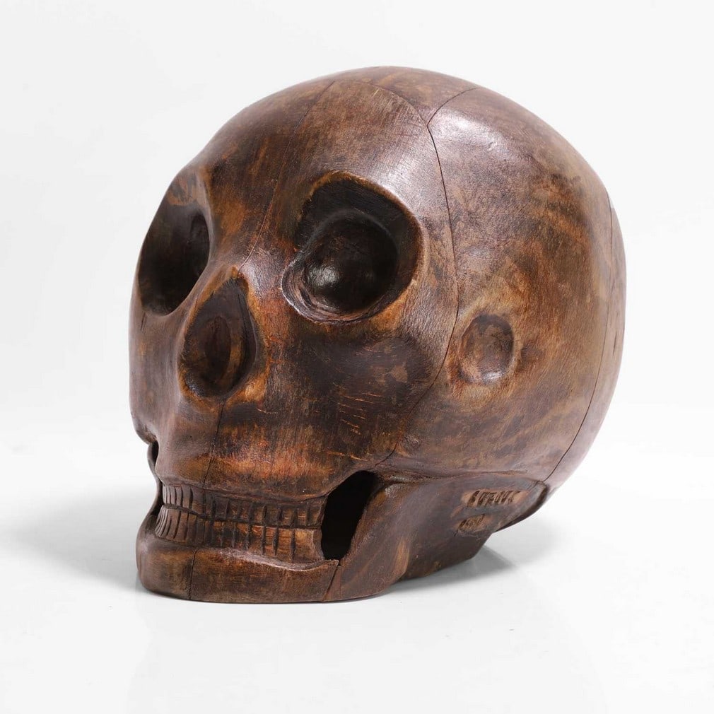 A carved wood model of a human skull, (1 of 7)