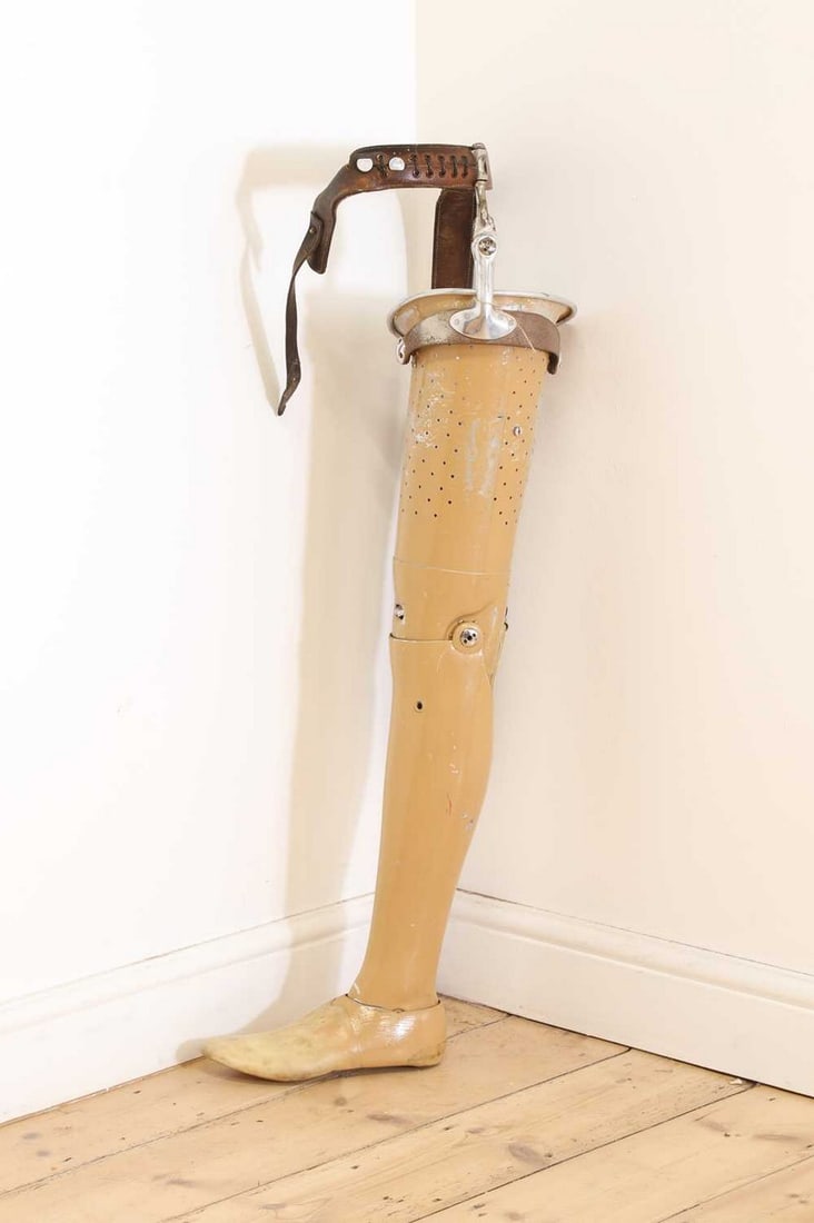 An aluminium prosthetic leg,: An aluminium prosthetic leg, 1950s, made by James E Hanger & Co., Nottingham, aluminium painted in a flesh tone, with leather fittings, with 'Hanger's Nottingham' metal label, 86cm high Condition Repo