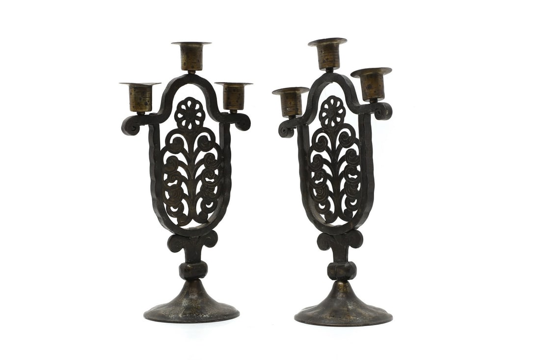 A pair of patinated iron and steel Arts and Crafts candlesticks,: A pair of patinated iron and steel Arts and Crafts candlesticks, 20th century, German, by Hugo Berger for Goberg, one stamped 'COBERG' and the other 'GERMANY' to the underside of the bases, 18cm wide