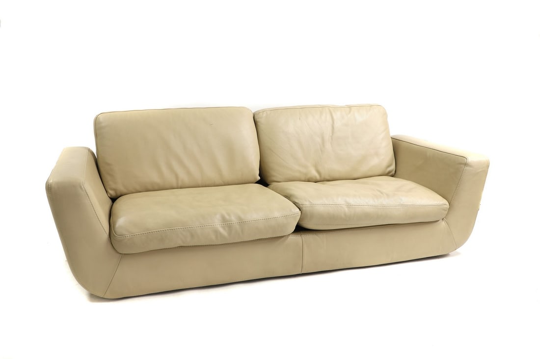 Two Roche Bobbois two-seater settees: Two Roche Bobbois two-seater settees upholstered in cream leather, of angular form with a cushioned back and seat 216cm wide 106cm deep 69cm high and; 231cm wide 102cm deep 70cm high Buying these sett