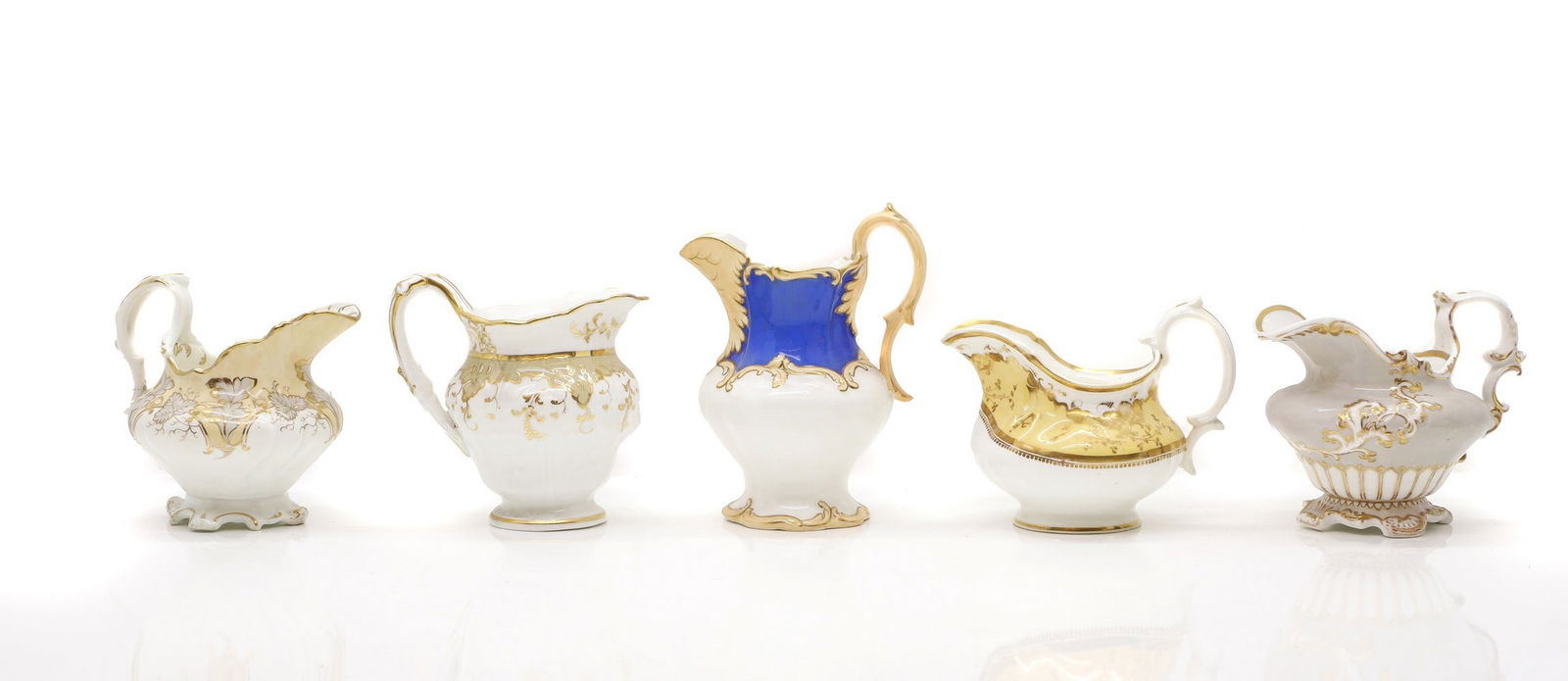 A collection of ten cream jugs,: A collection of ten cream jugs, 19th century, to include stoneware and bone china examples, of various forms, to include a Coalport and Minton example, all with gilt and foliate decoration, 16cm high