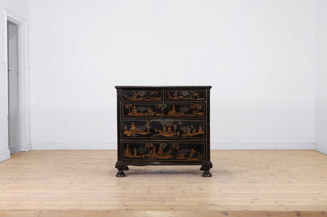 A black and gilt japanned chest of drawers,: A black and gilt japanned chest of drawers, early 18th century and later, decorated with chinoiserie motifs, fitted with two short over three long drawers, on bun feet, with some refreshed decoration,