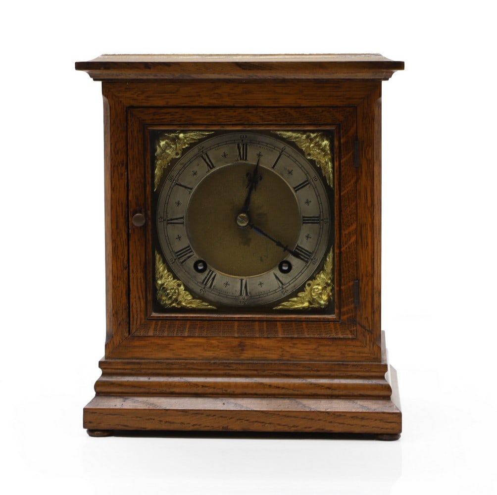 An oak cased mantle clock: An oak cased mantle clock early 20th Century, the movement stamped Winterhalder and Hofmeier, striking a gong, complete with pendulum and key, the dial signed John Walker, 230 Regents Street, 21cm wid