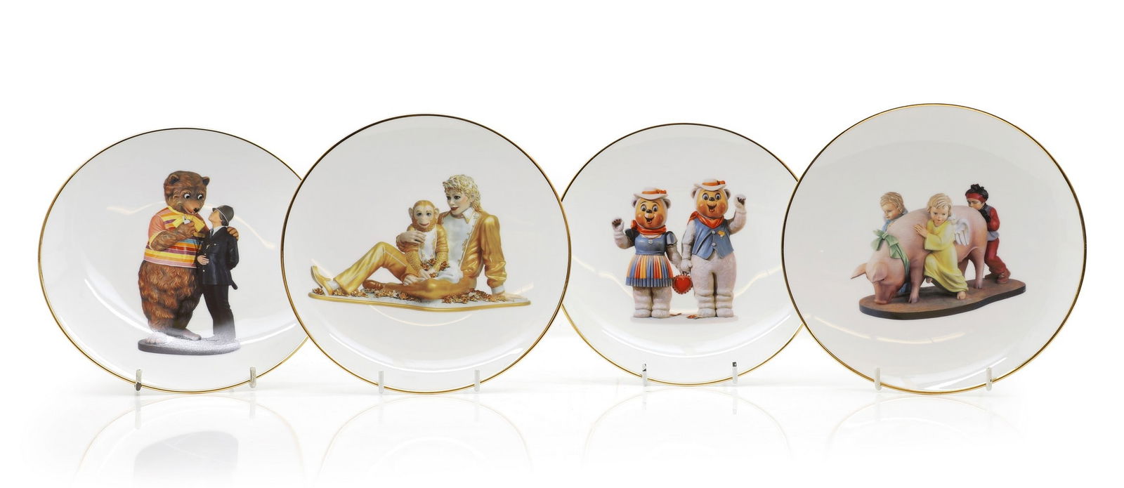 A set of four Bernardaud by Jeff Koons porcelain plates: A set of four Bernardaud by Jeff Koons porcelain plates of recent manufacture, decorated with images from Jeff Koons' 'Banality' series, with gilt edges, printed 'Banality Series Jeff Koons Edition li