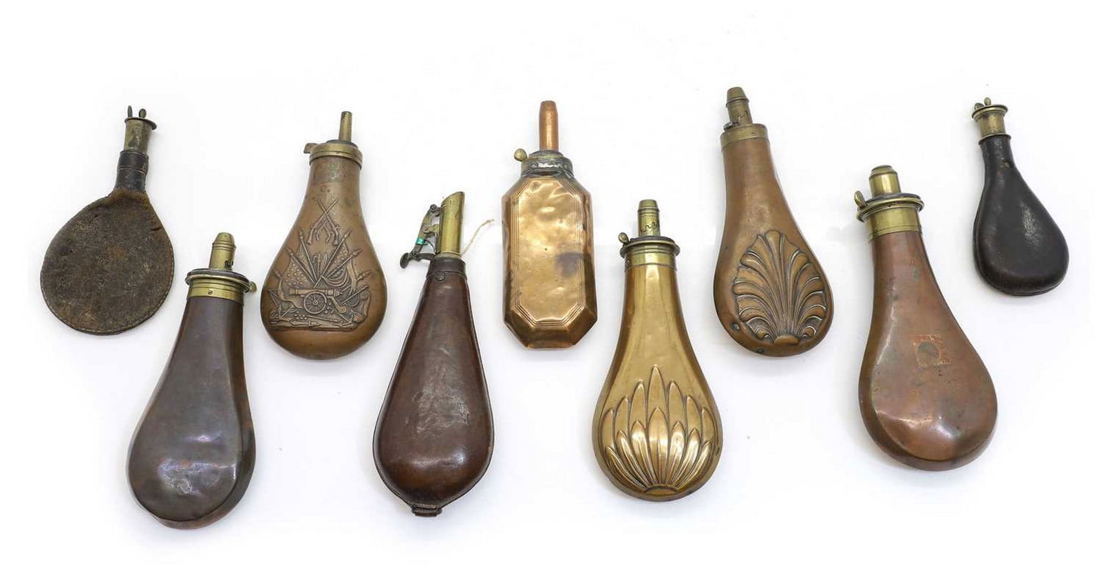 Six Victorian copper and brass shot and powder flasks,: Six Victorian copper and brass shot and powder flasks, together with three leather mounted flasks, the largest 22.5cm long (9) Shipping Disclaimer: Buyers must be aware of their country’s shippi