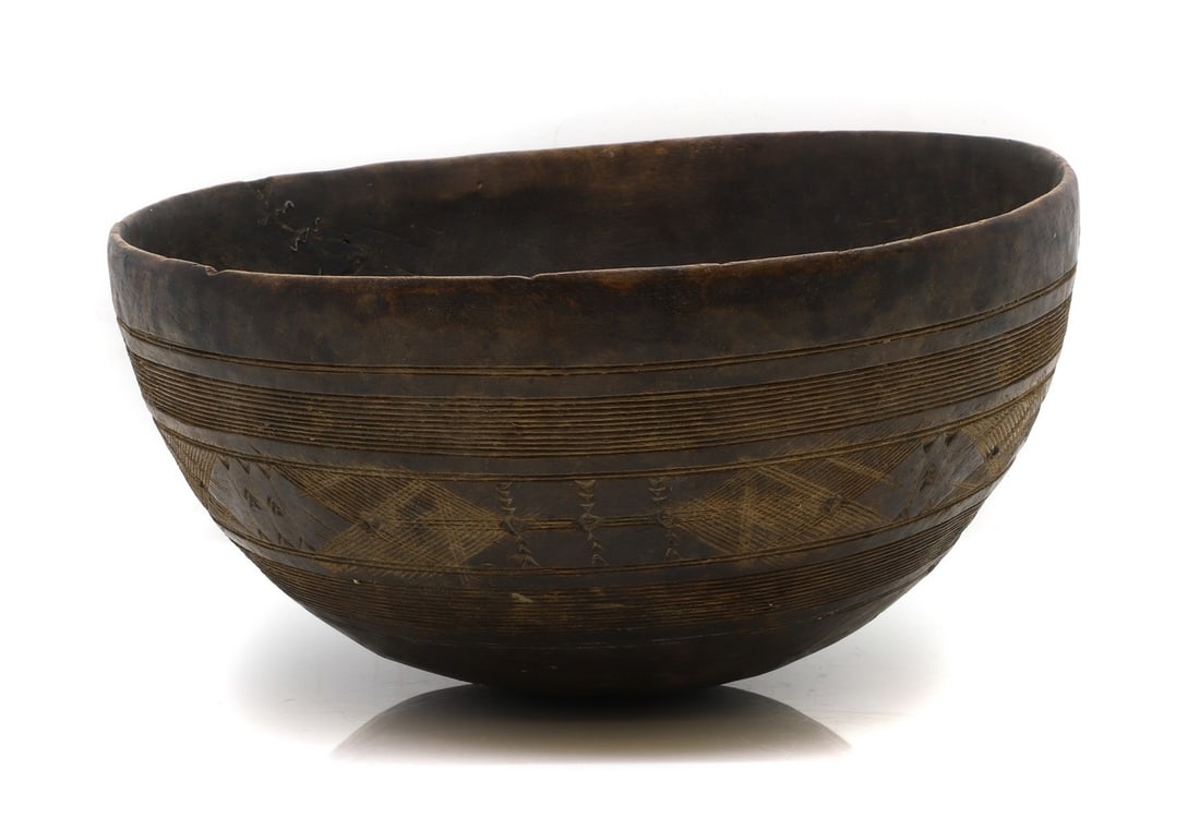 A Tuareg carved wood bowl,: A Tuareg carved wood bowl, early 20th Century, North African, 35cm diameter Condition Report: Repairs