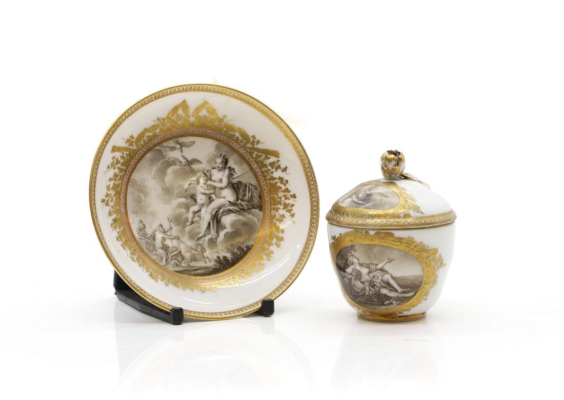 A Meissen porcelain cup and saucer: A Meissen porcelain cup and saucer late 18th to early 19th century, with en grisaille Classical scenes decoration, to gilt borders, underglaze blue crossed swords mark, the saucer 10.5cm diameter the 