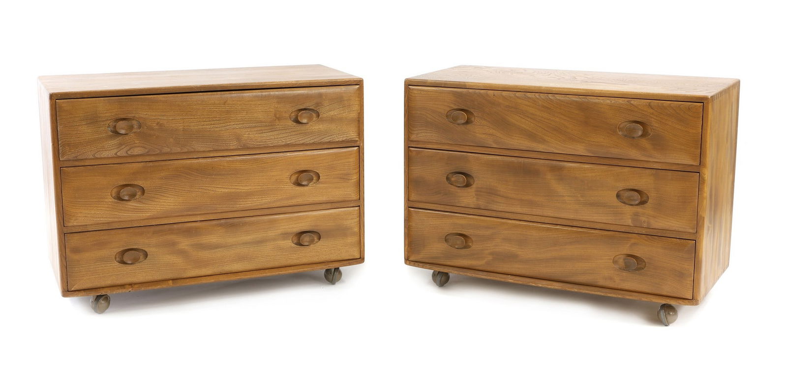 A pair of Ercol 'Windsor' chest of drawers,: A pair of Ercol 'Windsor' chest of drawers, c.1960s, designed by Lucian Ercolani, Model 483 commode in blonde elm, with three long drawers, 91cm wide 45cm deep 66cm high (2) Condition Report: Surface