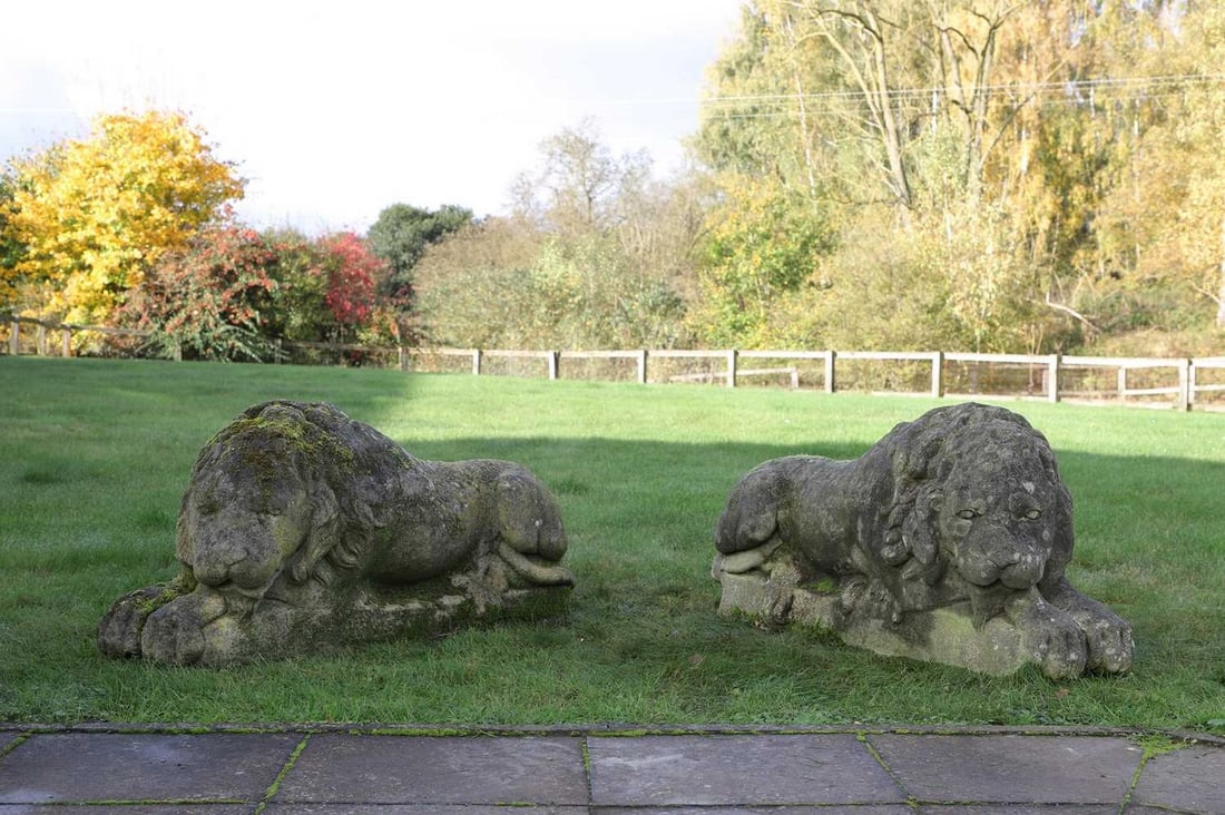 A pair of composition stone lions, (1 of 7)