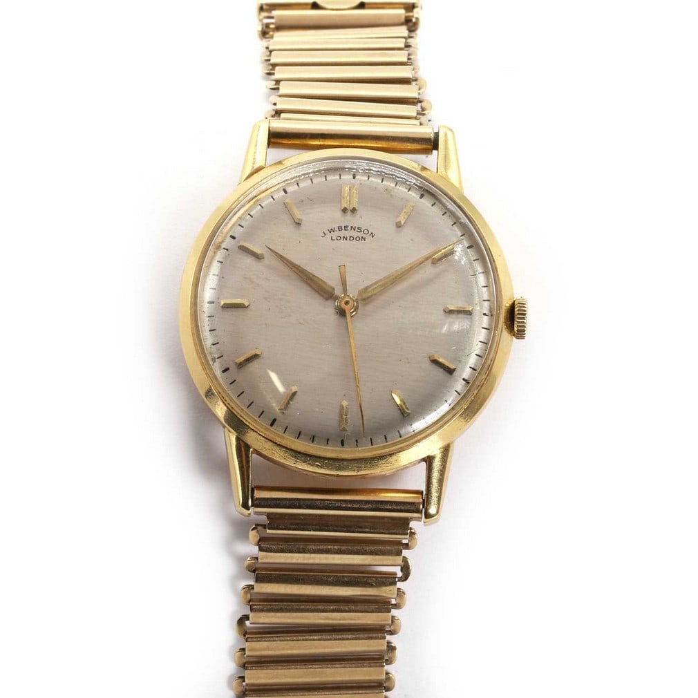 An 18ct gold JW Benson watch on a later 9ct gold bracelet,: An 18ct gold JW Benson watch on a later 9ct gold bracelet, with a circular 32mm diameter case, a silvered dial, applied gilt baton hour markers, gilt sword hands, centre second sweep, London 1959, to