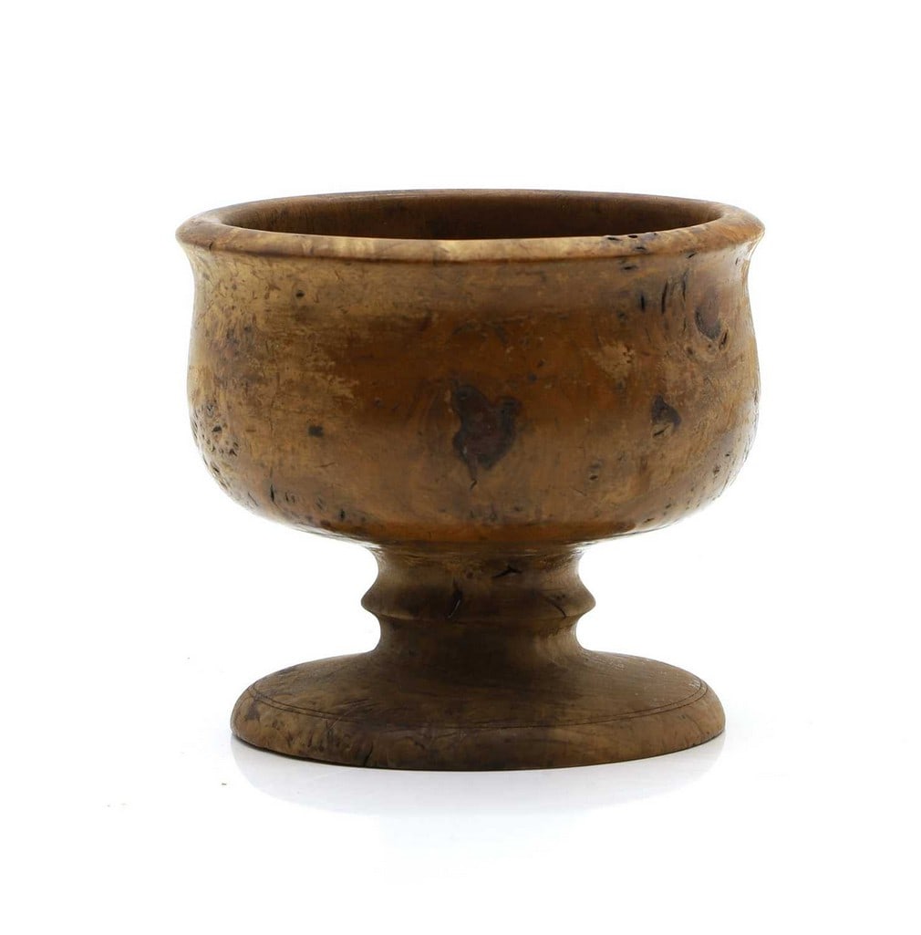 A small burr wood mazer bowl: A small burr wood mazer bowl early 19th Century, on a turned foot 11.5cm diameter 10cm high Condition Report: splits knocks and wear throughout, surface degraded in places