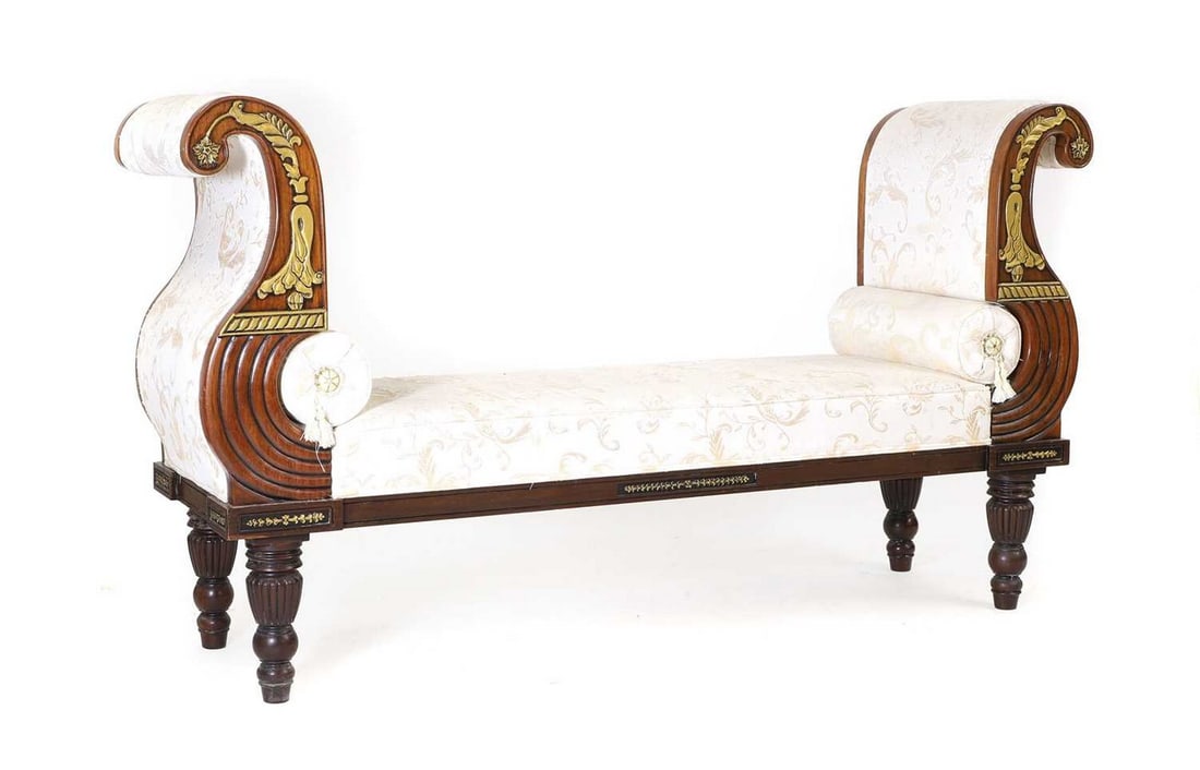 A Regency style mahogany chaise longue: A Regency style mahogany chaise longue of recent manufacture, with gilt highlights and reeded and turned legs, complete with two baulster cushions 180cm wide 48cm deep 100cm high