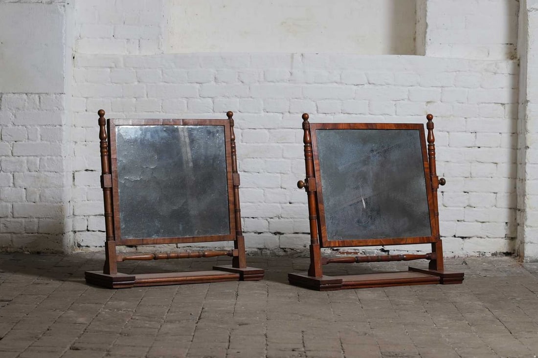 Two Regency mahogany dressing table mirrors,: Two Regency mahogany dressing table mirrors, 19th century, each with a rectangular plate and ring-turned supports, on a weighted platform stand, approximately 68cm wide 25cm deep 67cm high (2) Conditi