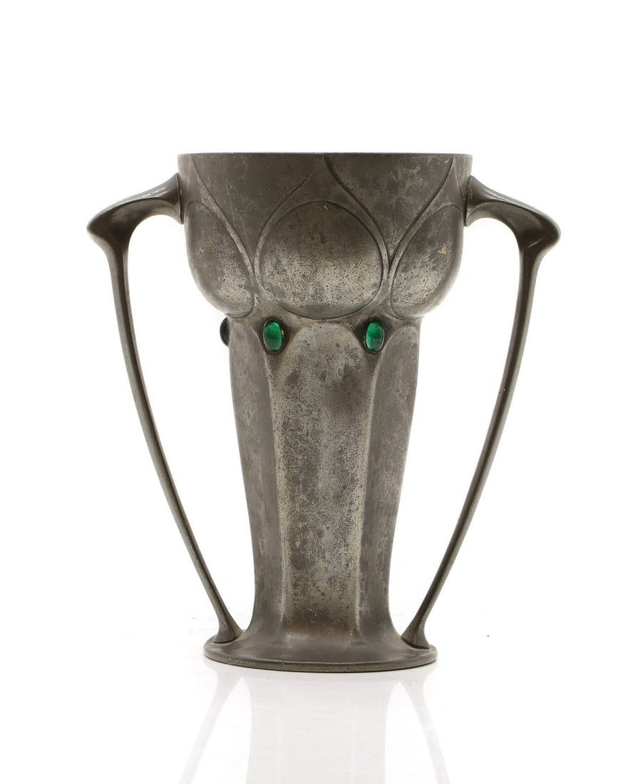 An Art Nouveau pewter twin handled vase,: An Art Nouveau pewter twin handled vase, c.1900, with a facet column, inset with oval cabochons, stamped indistinctly, 16cm high Condition Report: With wear. Fair. Some knocks to the rim.
