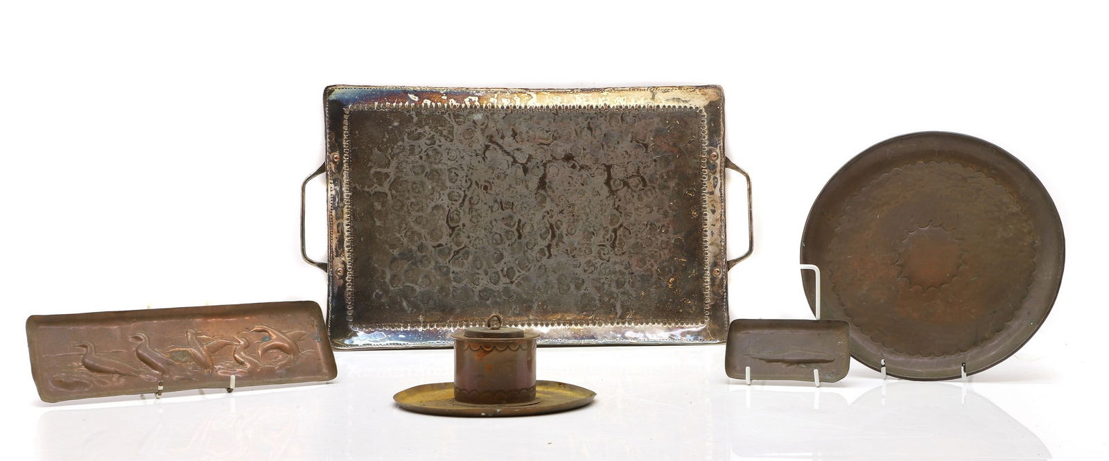John Pearson (1859-1930): John Pearson (1859-1930) c.1900, a silvered copper twin-handled tray, with struck banding, stamped with 'JP', 45 x 26cm, together with four further items of Arts and Crafts copper wares, all unmarked,
