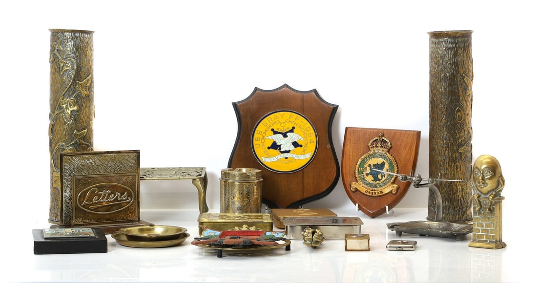 A group of various trench art: A group of various trench art a pair of large shell vases decorated with ivy leaves, a trivet, two Christmas tins, two regimental shields etc the large shell vases 9cm diameter 35cm high Condition Rep