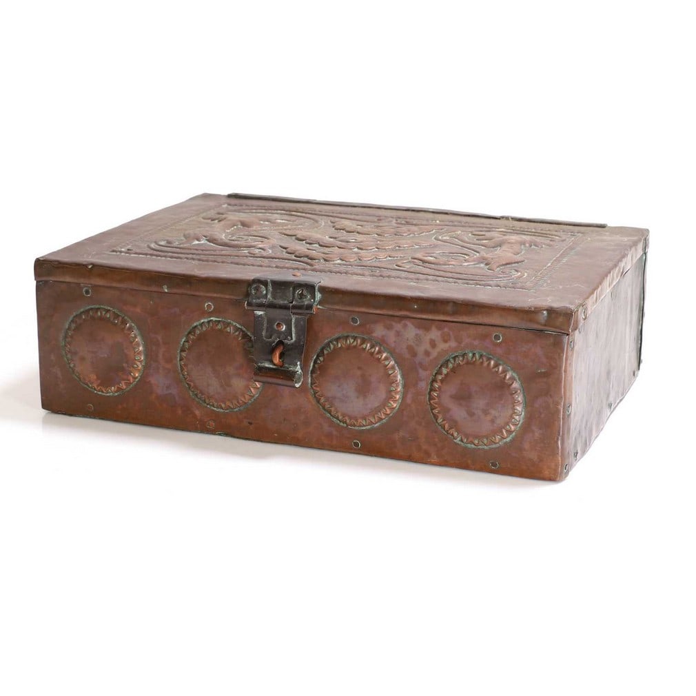 John Pearson (1859-1930),: John Pearson (1859-1930), a copper casket, dated '1907', the lid embossed with grotesques, the front with stylised discs, with a scrolled catch, the interior stained green, signed 'JP 1907', 36cm wide