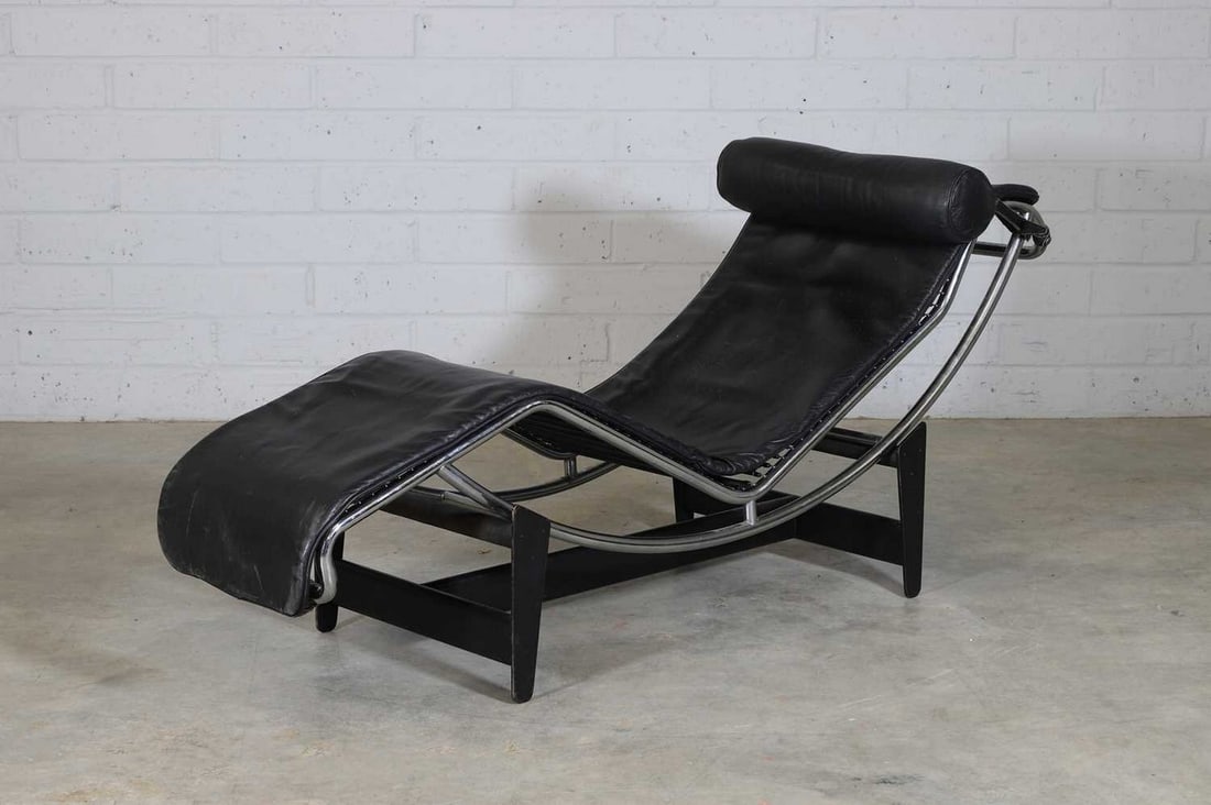 Charlotte Perriand, Pierre Jeanneret and Le Corbusier,: Charlotte Perriand, Pierre Jeanneret and Le Corbusier, an 'LC4' chaise, c.1990s, originally designed in 1928, manufactured by Cassina, upholstered in black leather complete with a black leather neck r