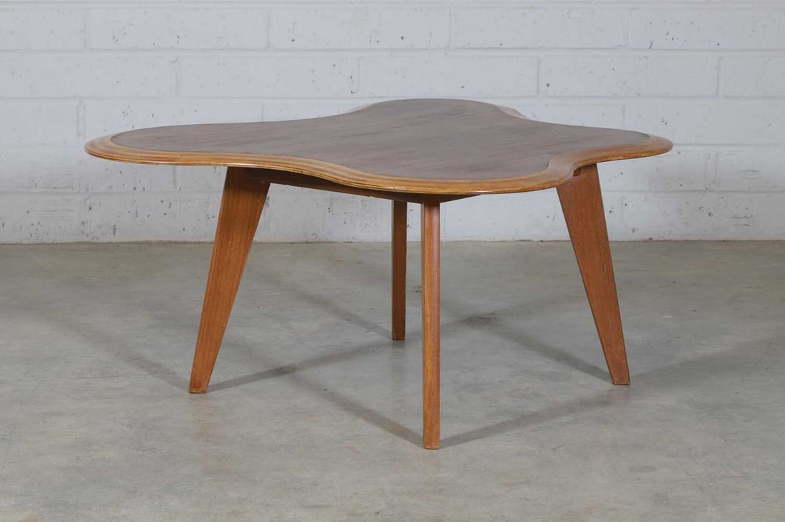 Neil Morris for Morris and Co., Glasgow,: Neil Morris for Morris and Co., Glasgow, a 'Cloud' table, c.1950, the shaped plywood top with a bevelled edge, raised on oblong tapering legs, 112cm wide 105cm deep 45cm high Condition Report: The top