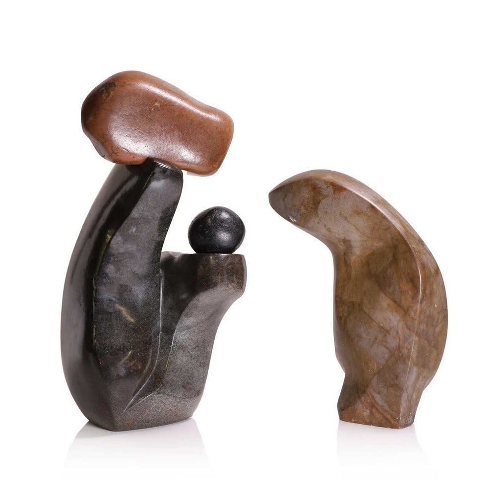 Two Zimbabwean Shona stone sculptures,: Two Zimbabwean Shona stone sculptures, 'Water Spirit' by Nicholas Mukomberanwa, a carved stone sculpture modelled as an abstract head, possibly a reptile, c.1990-91, with artist signature 'NMWK' to th