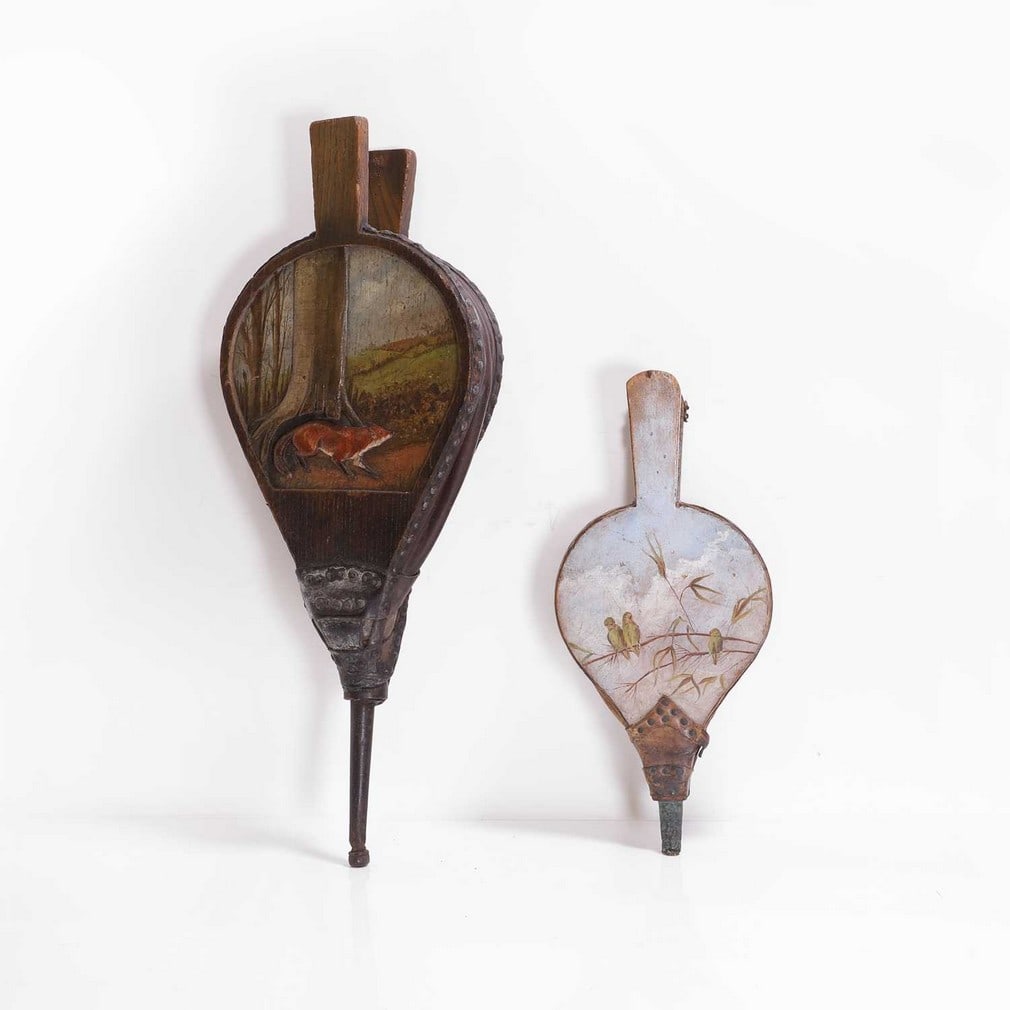 A pair of oak bellows: A pair of oak bellows 20th century, painted and carved with a fox in a landscape, 56cm long, together with another beechwood pair, painted with three birds on a branch 37cm long (2) Condition Report: