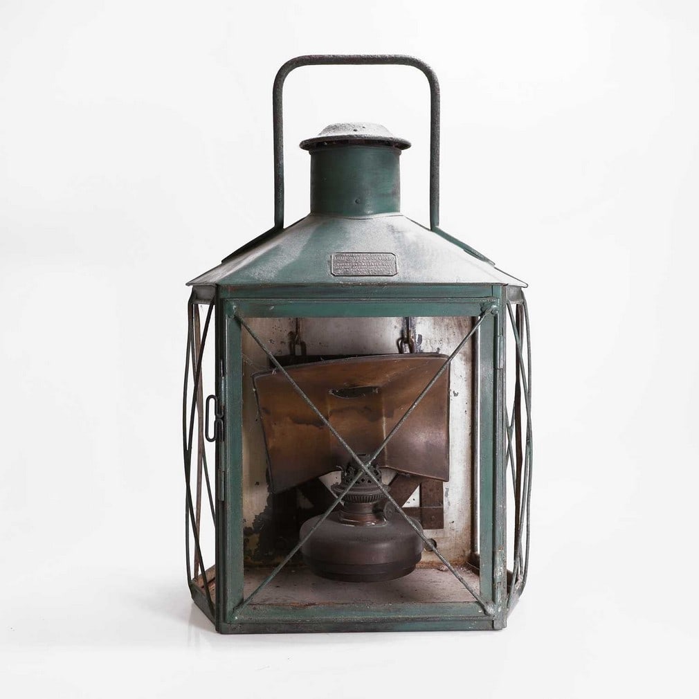 A painted tinplate paraffin lantern,: A painted tinplate paraffin lantern, 20th century, French, by J Guichard & C Couvard, 33cm wide 25cm deep 55cm high Condition Report: Lacking glass