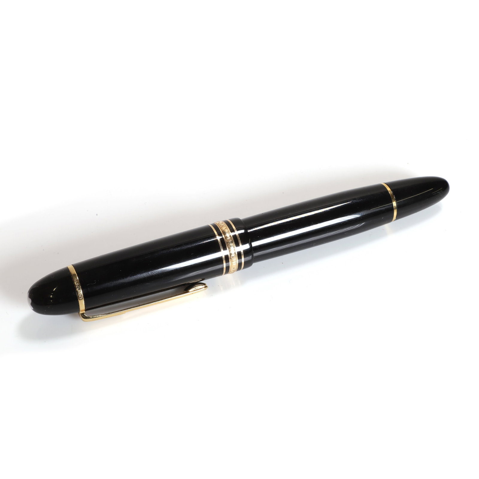 A Montblanc fountain pen,: A Montblanc fountain pen, the black screw cap and barrel with gilt clip and bands, the cap and nib signed Montblanc, the nib stamped 4810 18K 750 Condition Report: Requires a new cartridge. End of bar