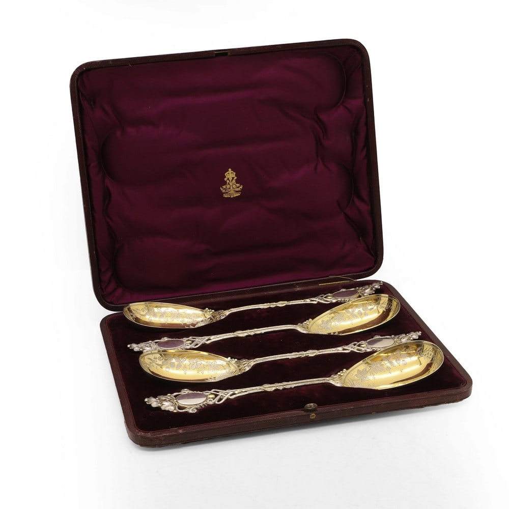 A set of four Victorian silver-gilt strawberry spoons,: A set of four Victorian silver-gilt strawberry spoons, by Frederick Elkington, London 1874, each graved with strawberries, fruit and pineapples to the bowls, each 25cm long, in a fitted case, 18ozt Co