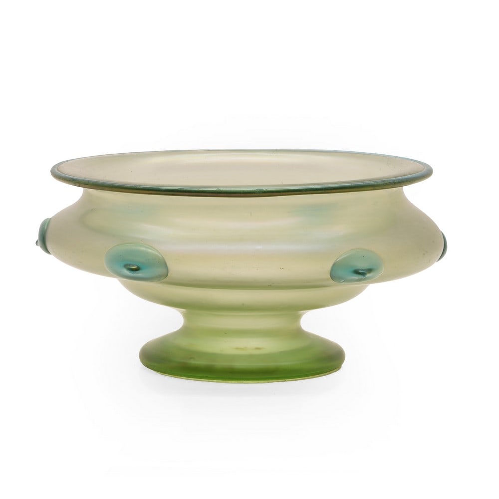 A Loetz 'Orpheus' glass bowl: A Loetz 'Orpheus' glass bowl c.1903, of footed form, with applied pale blue prunts to a pale green, the whole with an iridescent finish, 27.5cm diameter 13.4cm high Condition Report: Minor surface wea