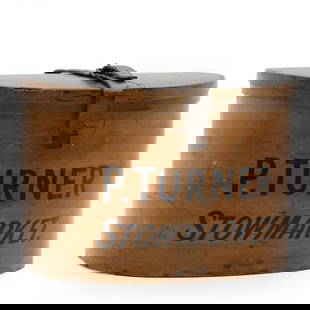 A wooden hat box,: A wooden hat box, inscribed 'P. Turner Stowmarket', with a leather top strap, 28cm wide 23cm deep 18.5cm high William Turner (1846-1934),was a Stowmarket draper, his son Philip John Turner was born in