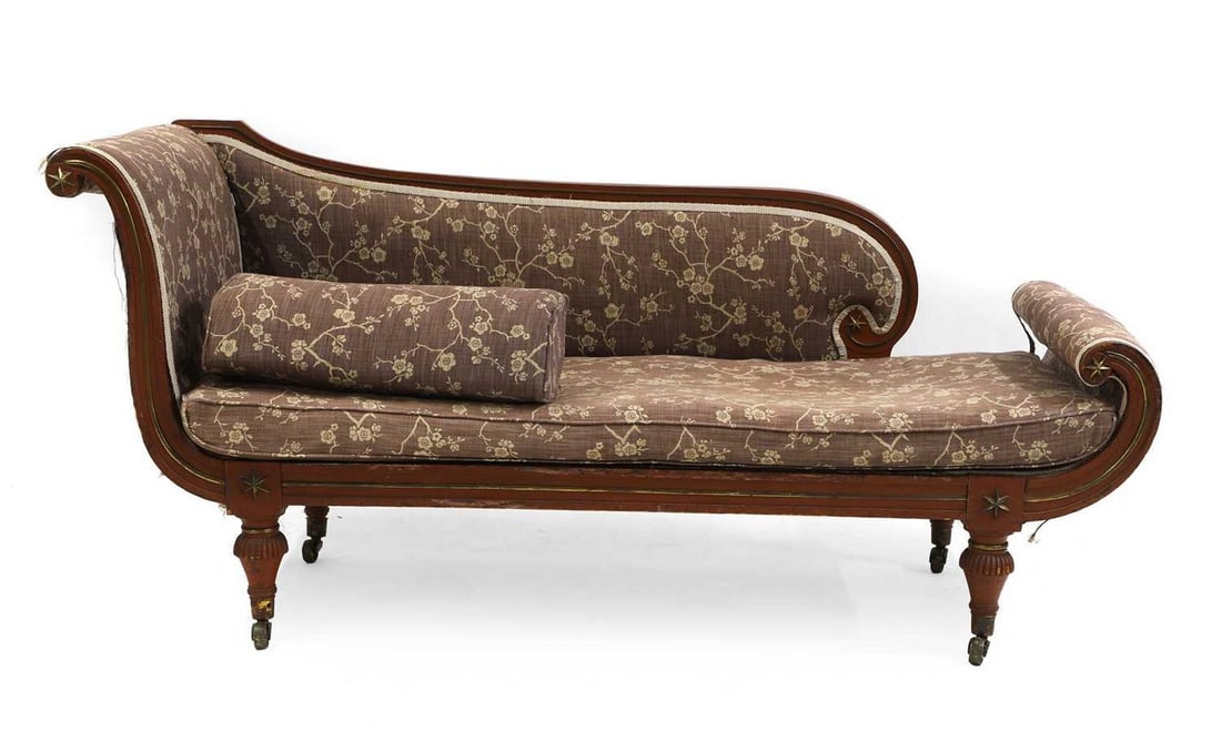 A Regency painted and gilt metal mounted chaise longue,: A Regency painted and gilt metal mounted chaise longue, early 19th century, the scrolling head shaped back and scrolling foot decorated with gilt metal stars, raised on turned legs and brass castors 1