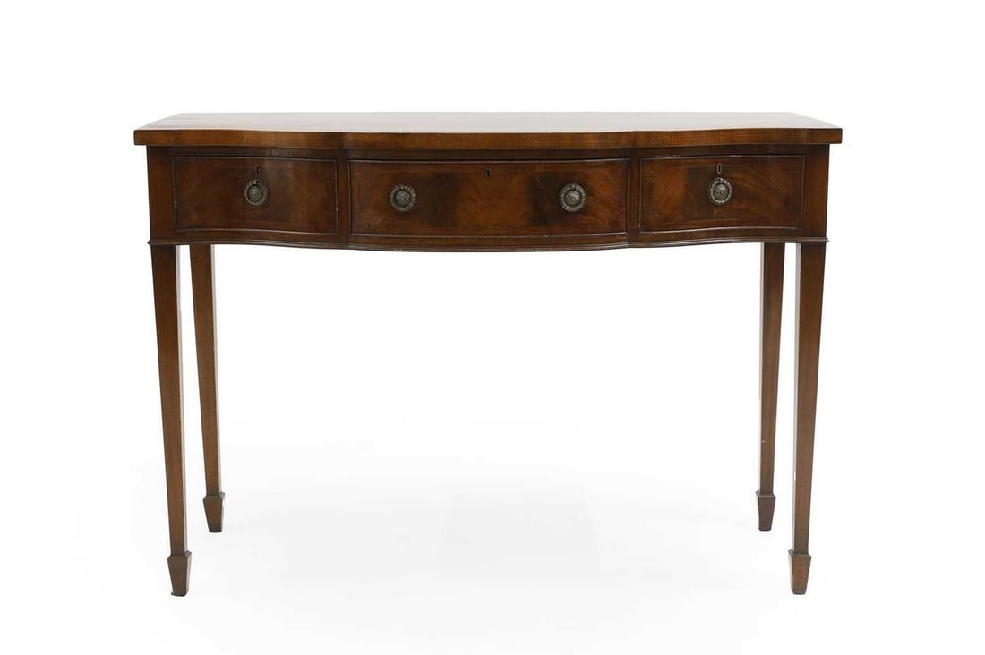 A George III style mahogany inlaid serving table,: A George III style mahogany inlaid serving table, with a serpentine front over three drawers riased on tapering supports and spade feet, 123cm wide 53.5cm deep 87cm high Condition Report: Scratches an
