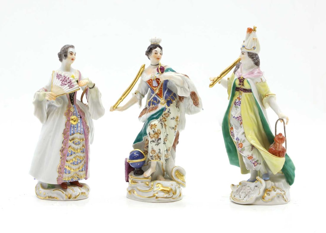 A Meissen figure,: A Meissen figure, 20th century, modelled as a regal woman with globe beside her foot, 15cm high, together with two other similar figures, woman in flowing gown with fan, 14cm high, and a woman wearing